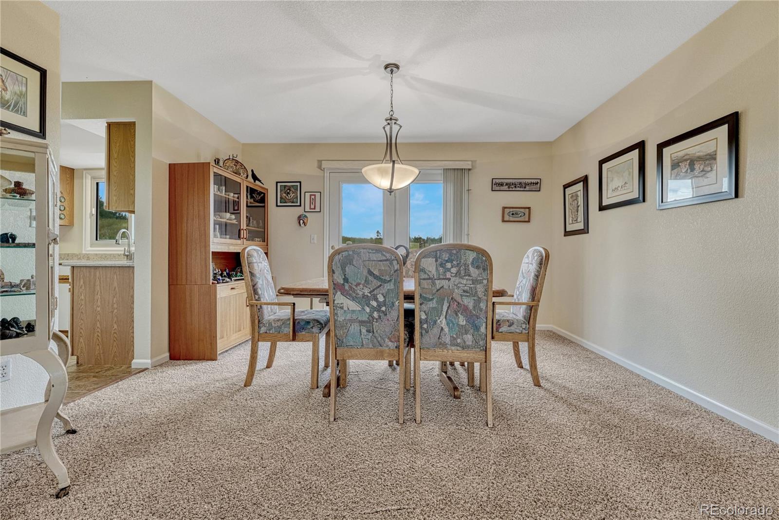 43793 Buckskin Road Parker, CO 80138 - Photo 12 of 50 a dining room with furniture and window