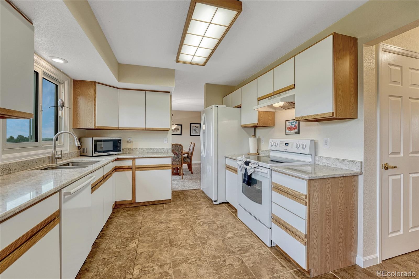 43793 Buckskin Road Parker, CO 80138 - Photo 14 of 50 a kitchen with stainless steel appliances granite countertop a sink and cabinets