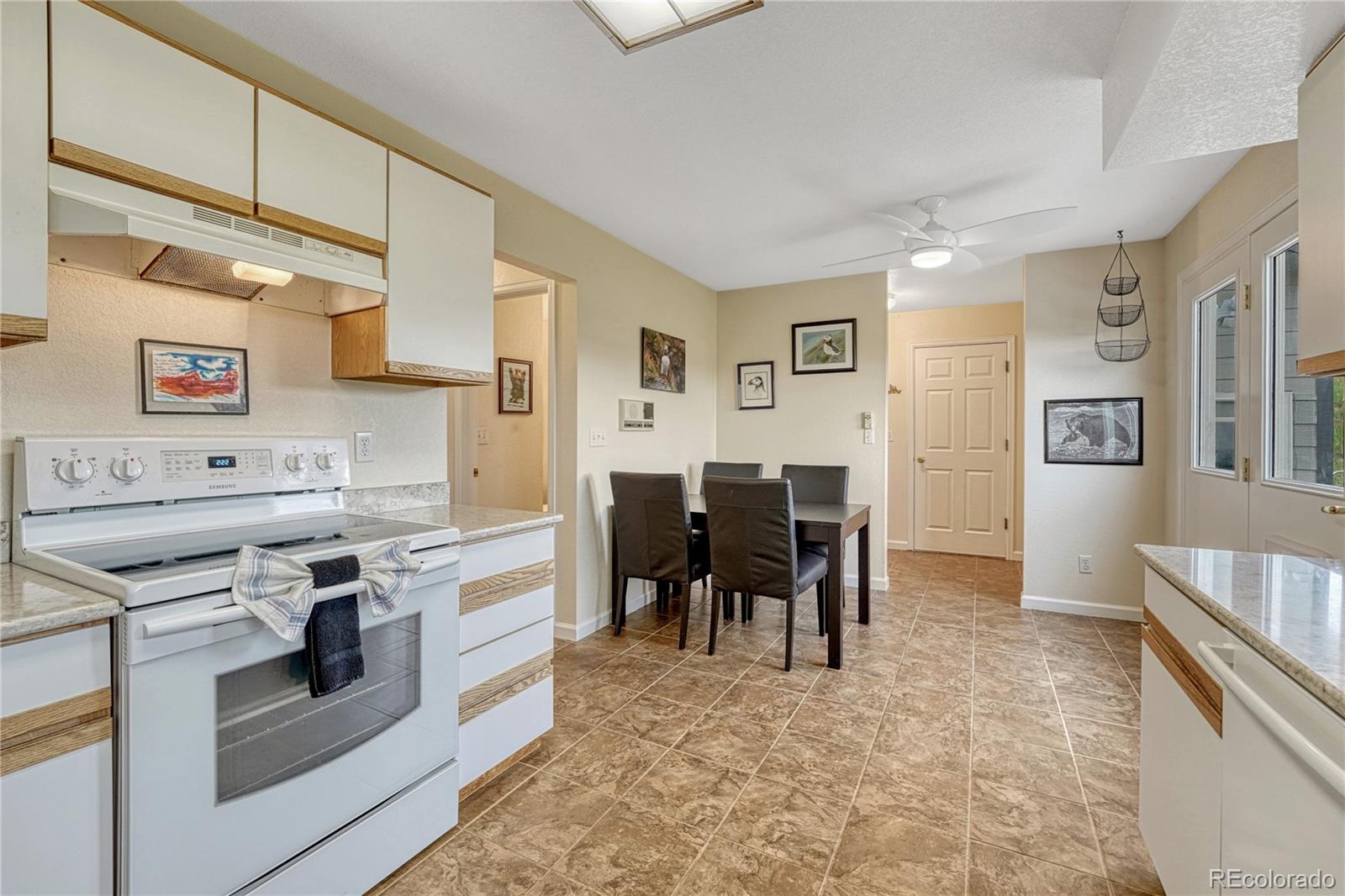 43793 Buckskin Road Parker, CO 80138 - Photo 16 of 50 a kitchen with a stove and cabinets