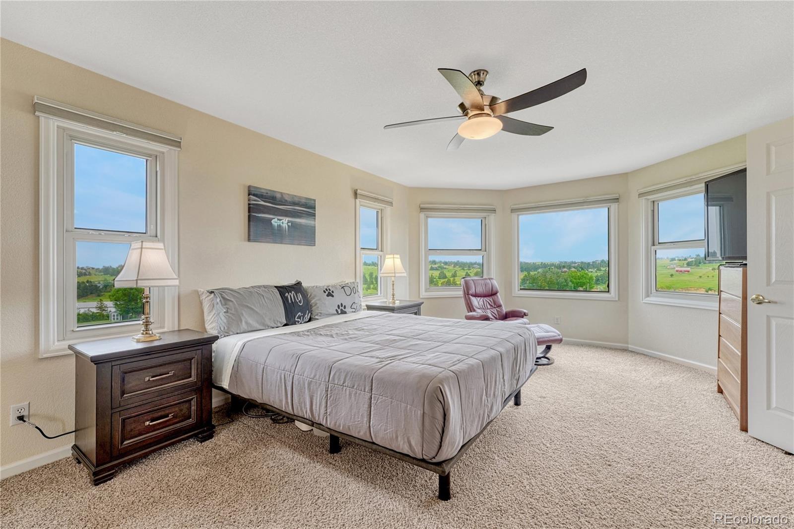 43793 Buckskin Road Parker, CO 80138 - Photo 23 of 50 a bedroom with a bed and a large window