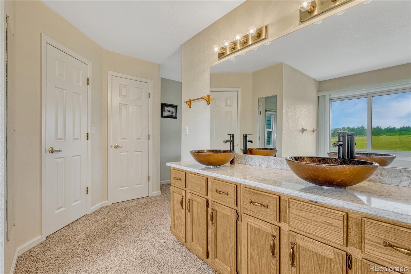 43793 Buckskin Road Parker, CO 80138 - Photo 25 of 50 a bathroom with a granite countertop sink and a mirror