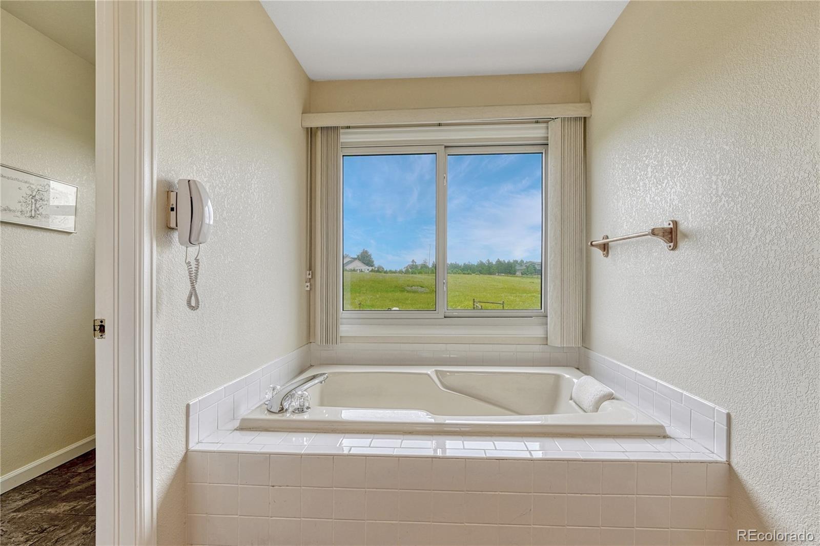 43793 Buckskin Road Parker, CO 80138 - Photo 26 of 50 a white bath tub sitting next to a window