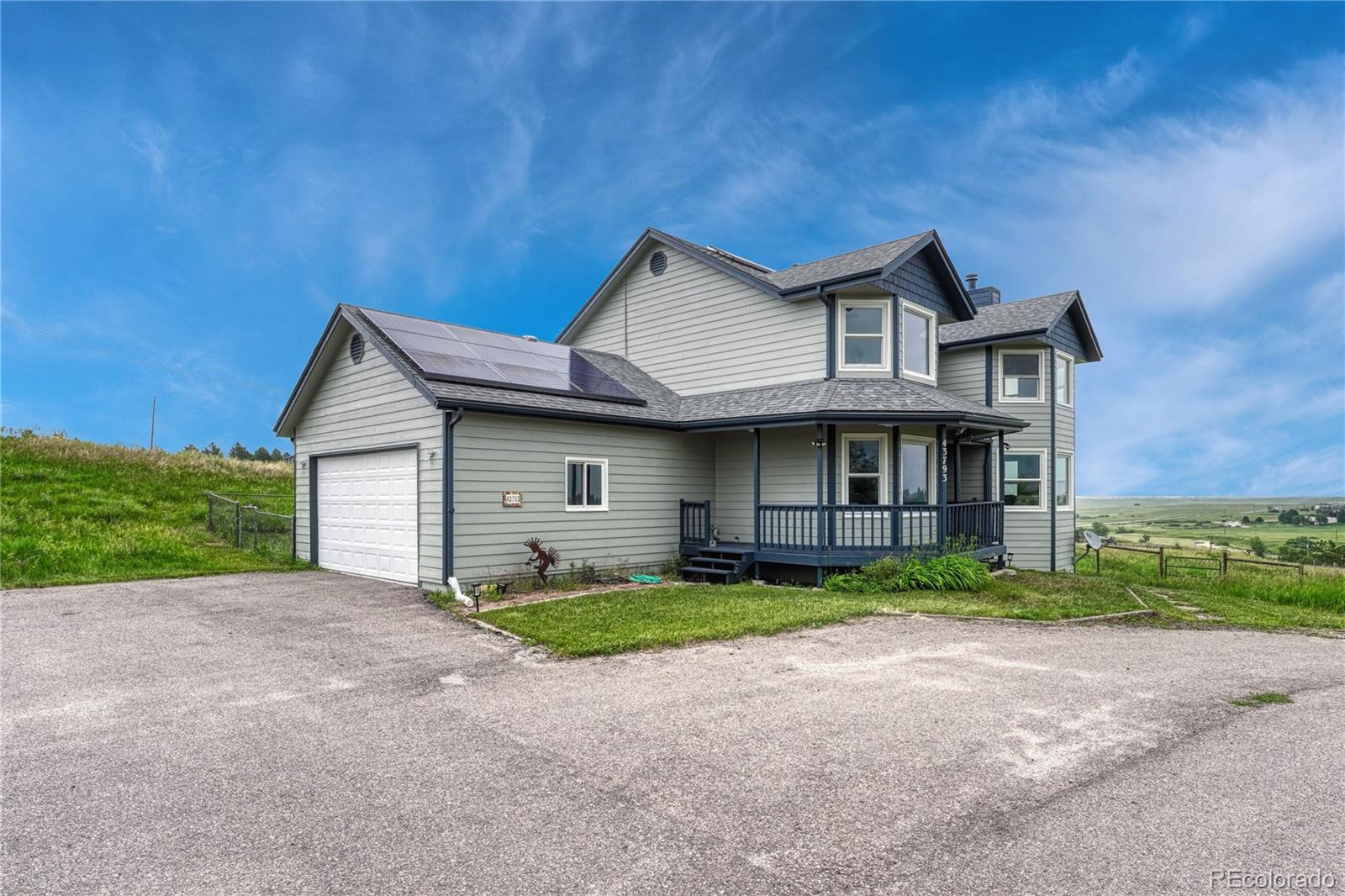 43793 Buckskin Road Parker, CO 80138 - Photo 3 of 50 a front view of a house with a yard and garage