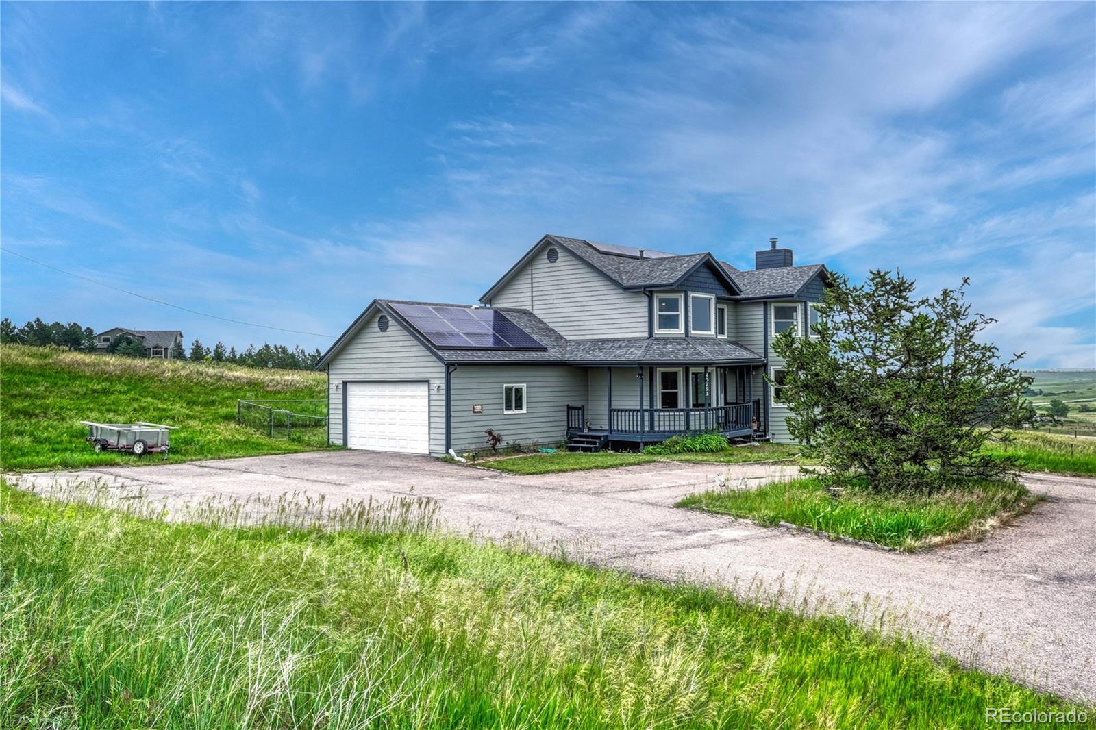 43793 Buckskin Road Parker, CO 80138 - Photo 42 of 50 a front view of a house with a yard and garage