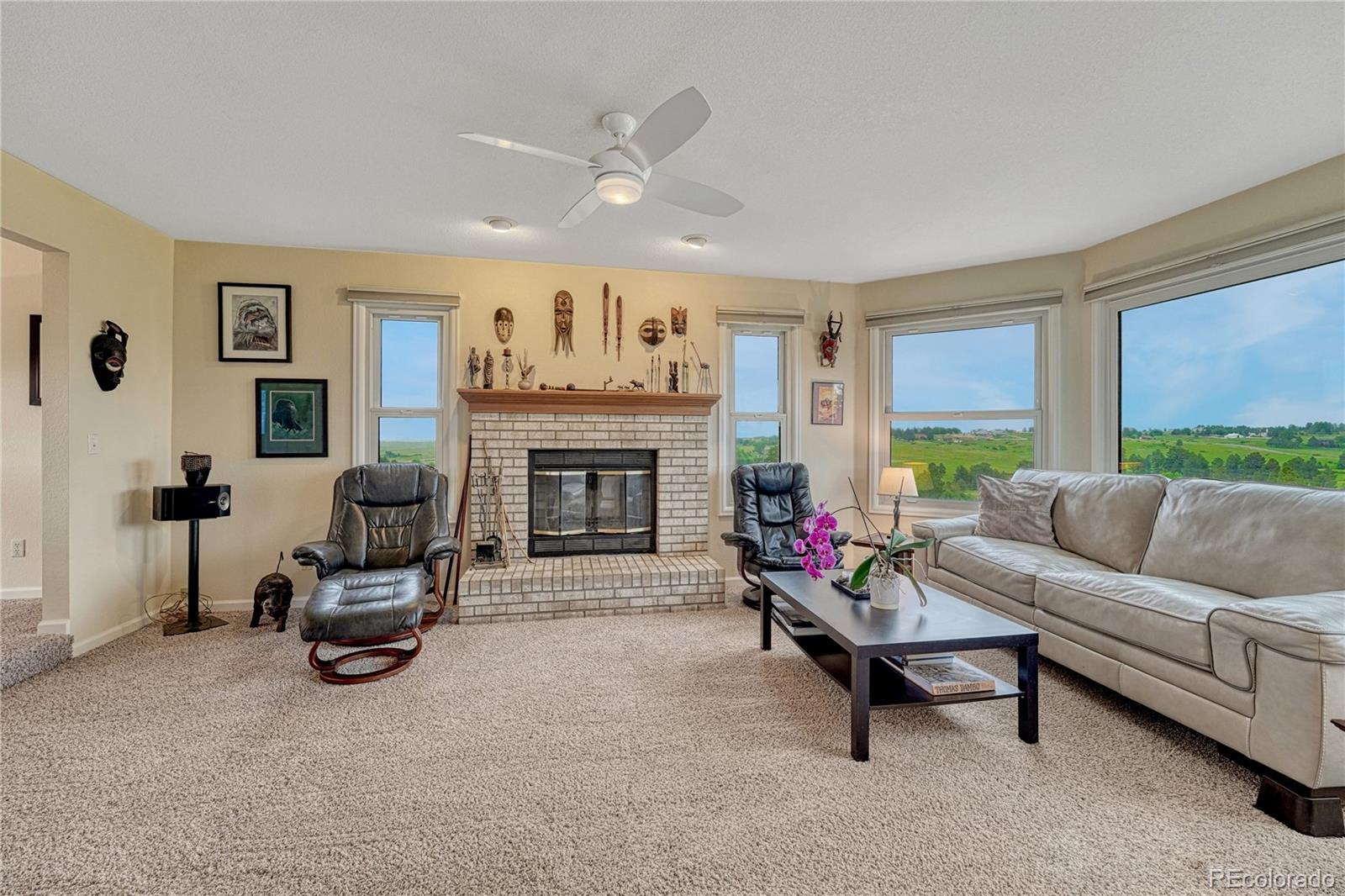 43793 Buckskin Road Parker, CO 80138 - Photo 9 of 50 a living room with furniture and a fireplace