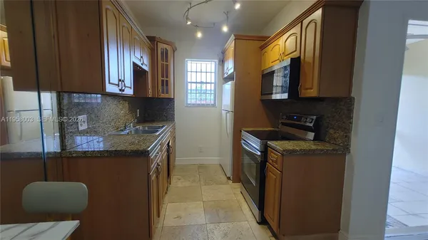 a kitchen that has a sink and a stove in it