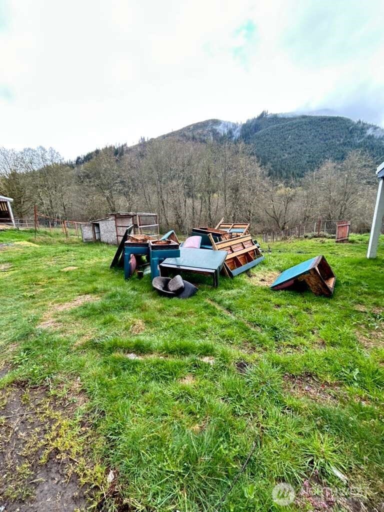 431 Highland Valley Road Morton, WA 98356 - Photo 13 of 34 a backyard of a house with table and chairs
