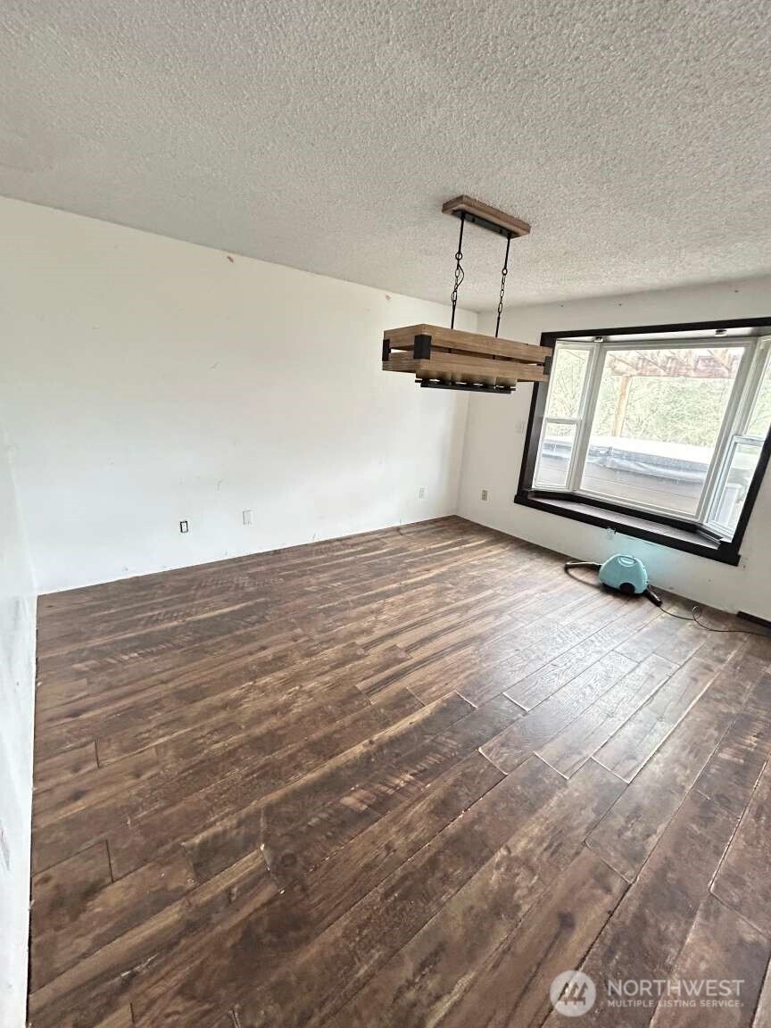 431 Highland Valley Road Morton, WA 98356 - Photo 28 of 34 a view of a room with wooden floor and white walls