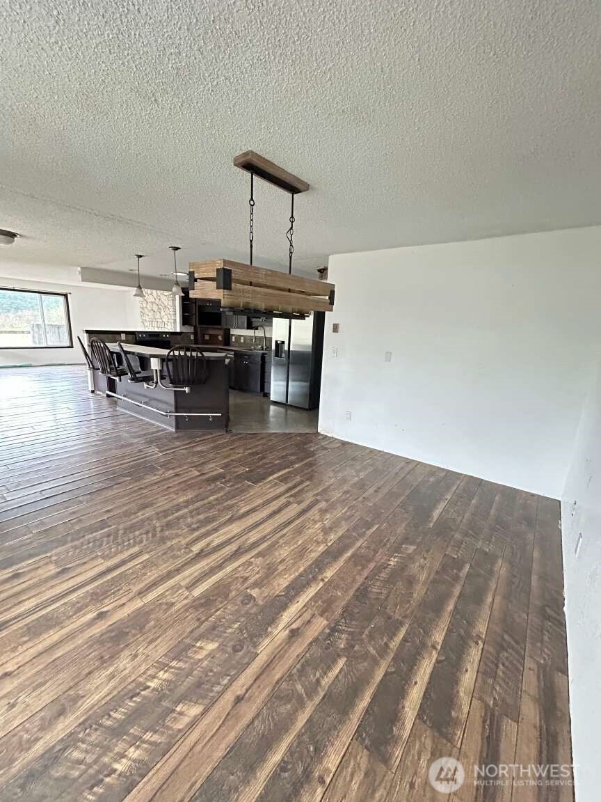 431 Highland Valley Road Morton, WA 98356 - Photo 29 of 34 a room with lots of chairs and wooden floor