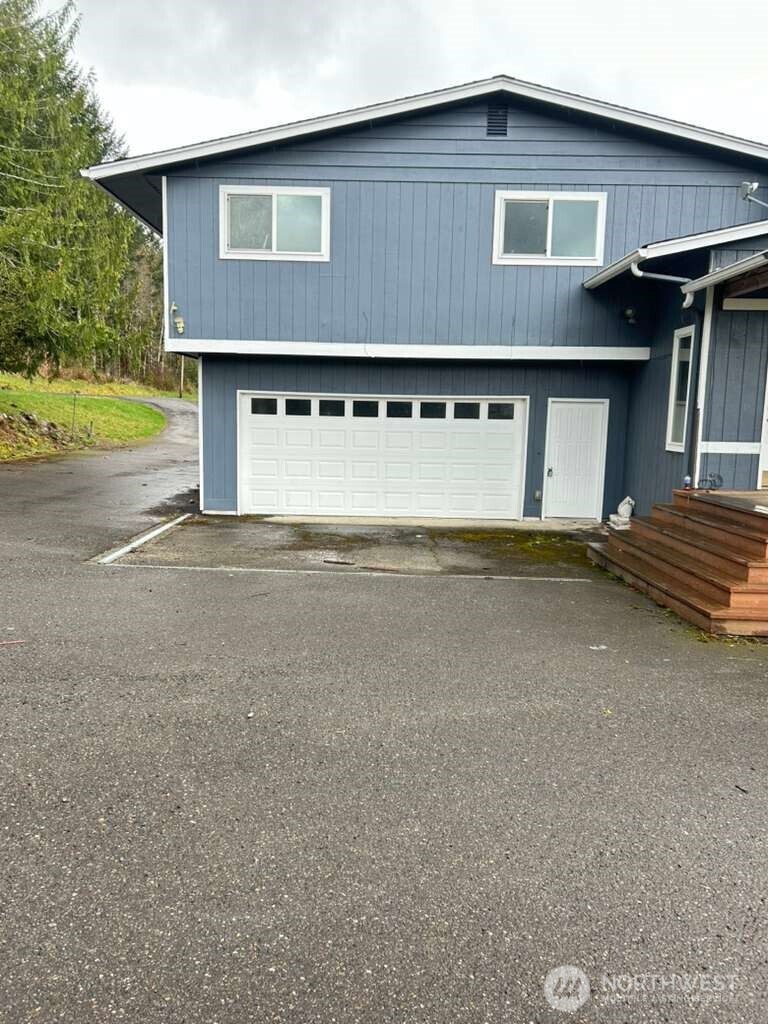 431 Highland Valley Road Morton, WA 98356 - Photo 3 of 34 a front view of a house with a yard and garage