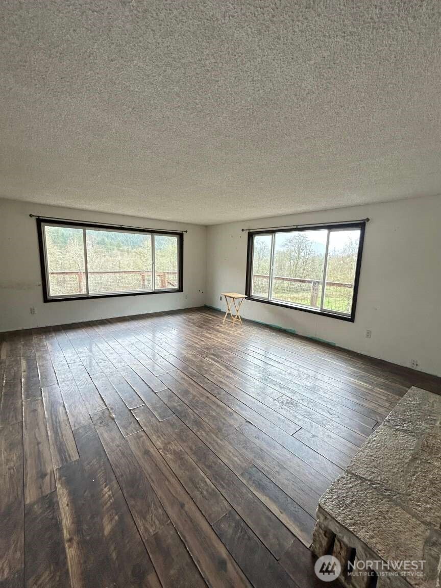 431 Highland Valley Road Morton, WA 98356 - Photo 32 of 34 wooden floor in an empty room with a window