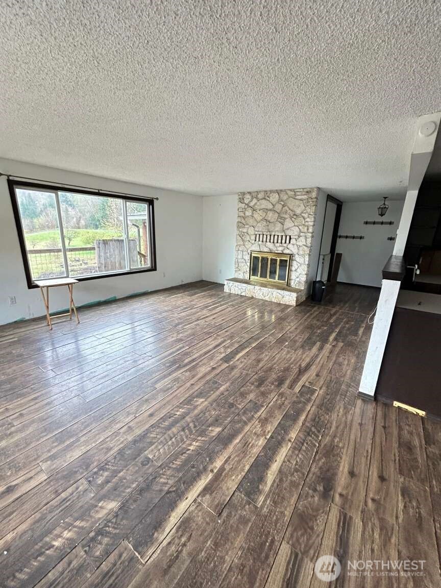 431 Highland Valley Road Morton, WA 98356 - Photo 34 of 34 an empty room with wooden floor and windows