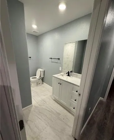 a bathroom with a sink toilet and mirror