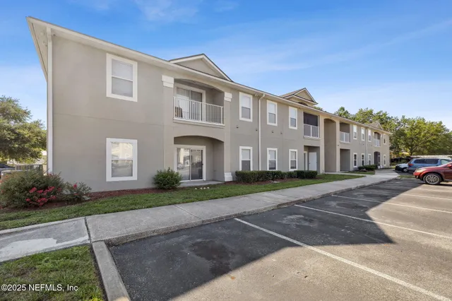a front view of a house with a yard and a garage