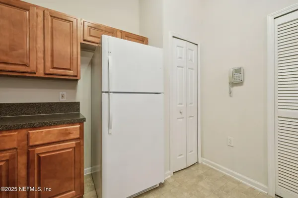 a white refrigerator freezer sitting inside of a kitchen