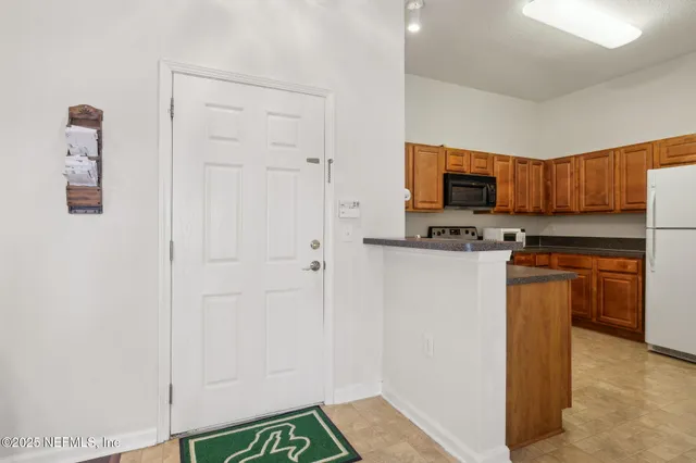 a kitchen with stainless steel appliances a refrigerator and a stove top oven