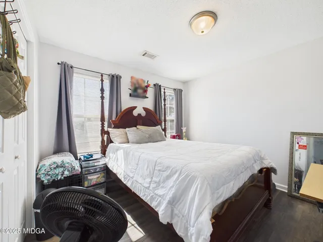 a bathroom with a sink and mirror with toilet