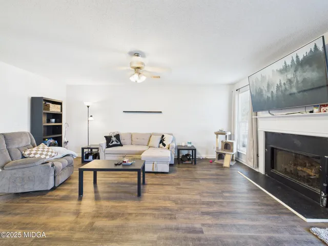 a view of a dining room with furniture and wooden floor