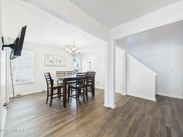 a view of a dining room with furniture and wooden floor