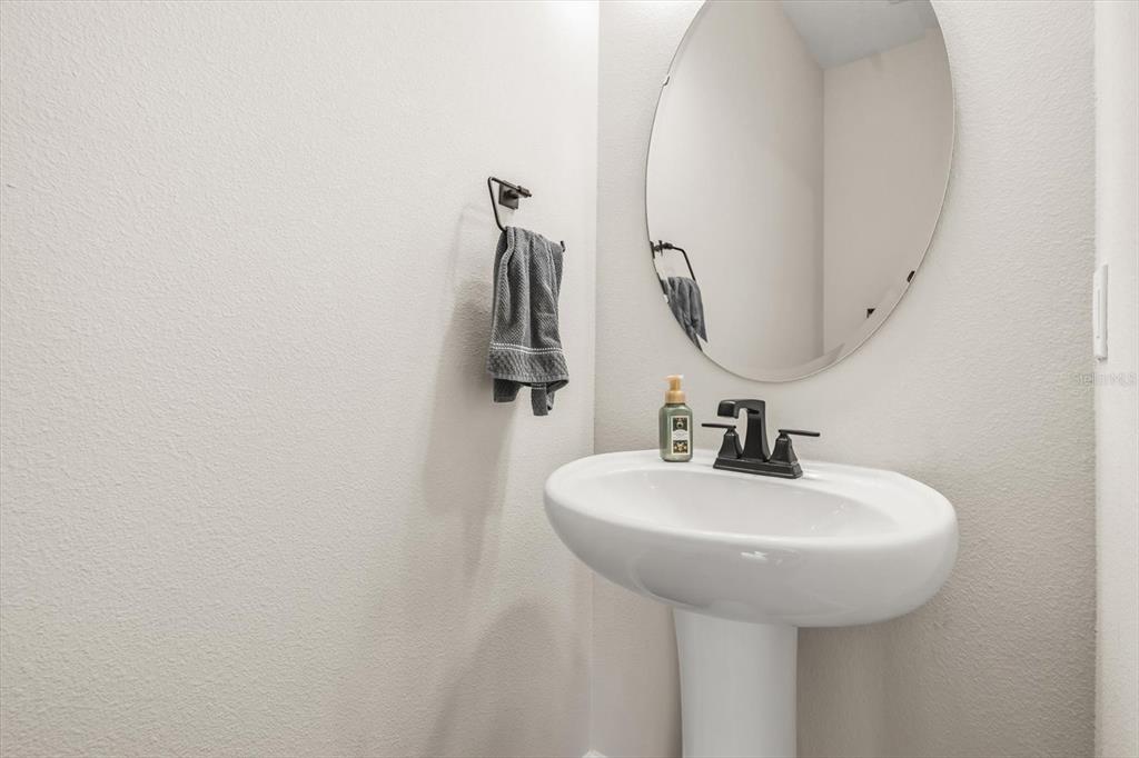 3657 Sublett Loop Tavares, FL 32778 - Photo 11 of 39 a bathroom with a sink and mirror