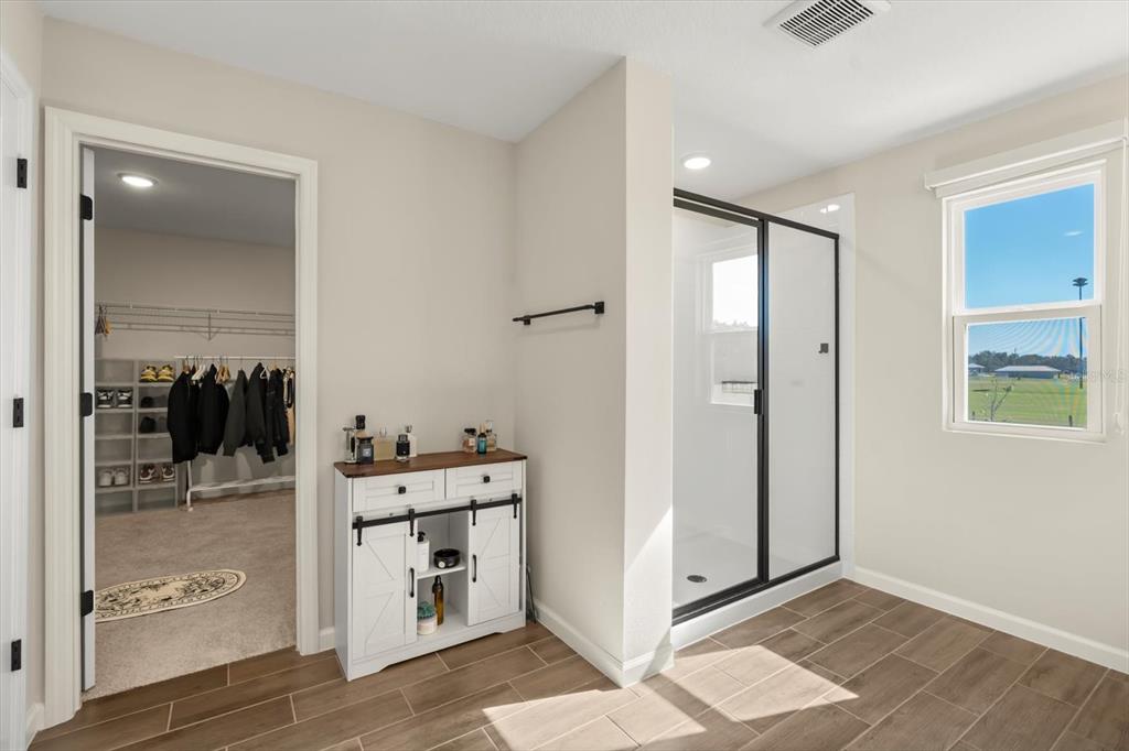 3657 Sublett Loop Tavares, FL 32778 - Photo 16 of 39 a view of a bathroom with a tub a sink and mirror