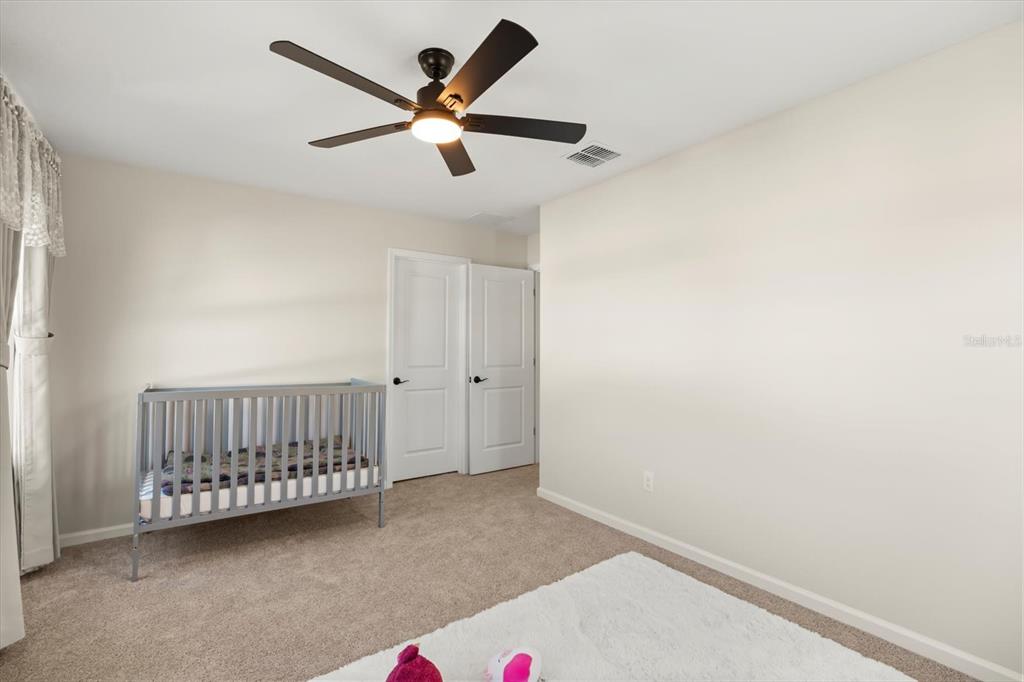 3657 Sublett Loop Tavares, FL 32778 - Photo 20 of 39 an empty room with a ceiling fan and a window