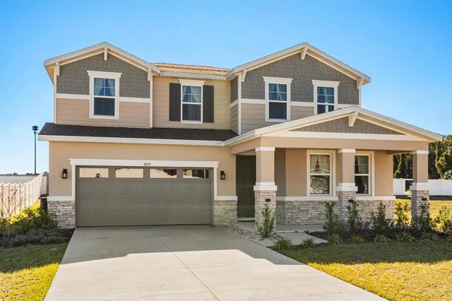 a front view of a house with a garage