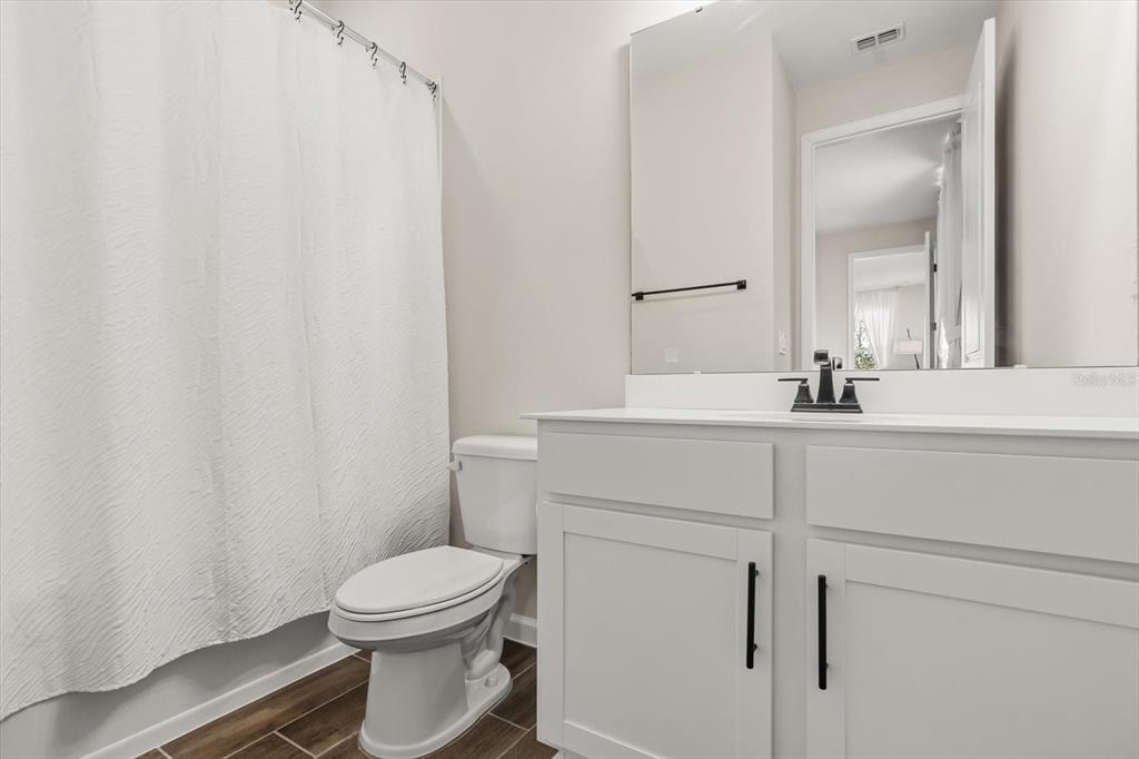 3657 Sublett Loop Tavares, FL 32778 - Photo 25 of 39 a bathroom with a sink a toilet and a mirror