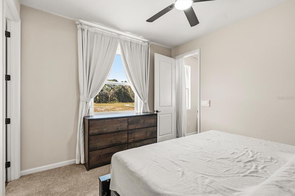 3657 Sublett Loop Tavares, FL 32778 - Photo 26 of 39 a bedroom with a bed and a window