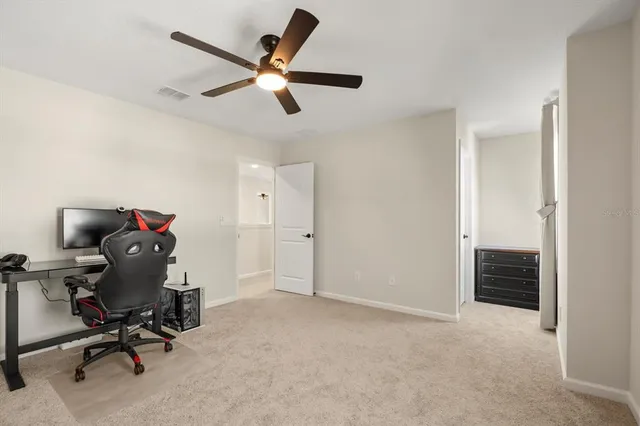 a view of workspace with a ceiling fan