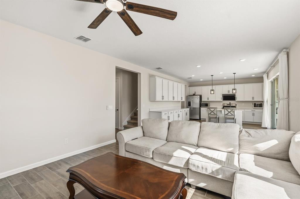3657 Sublett Loop Tavares, FL 32778 - Photo 5 of 39 a living room with furniture and a view of kitchen