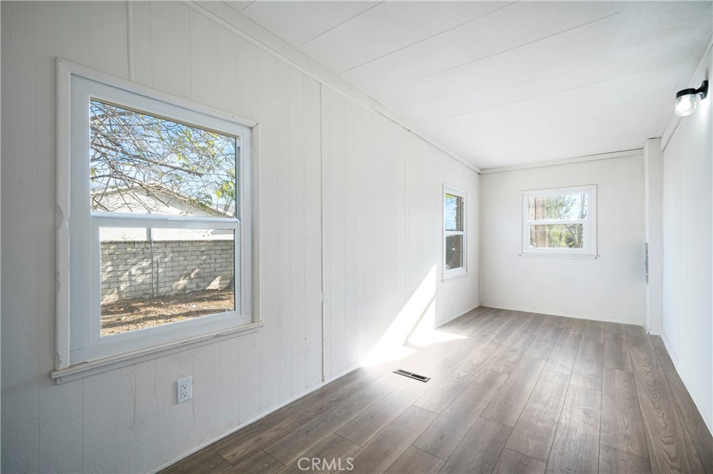 9106 Kennedy Street Riverside, CA 92509 - Photo 13 of 24 a view of an empty room with wooden floor and a window