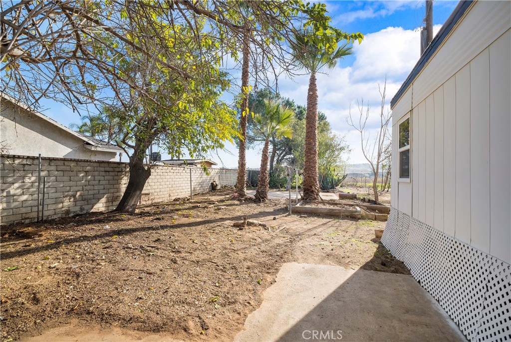 9106 Kennedy Street Riverside, CA 92509 - Photo 16 of 24 a view of a backyard with a tree
