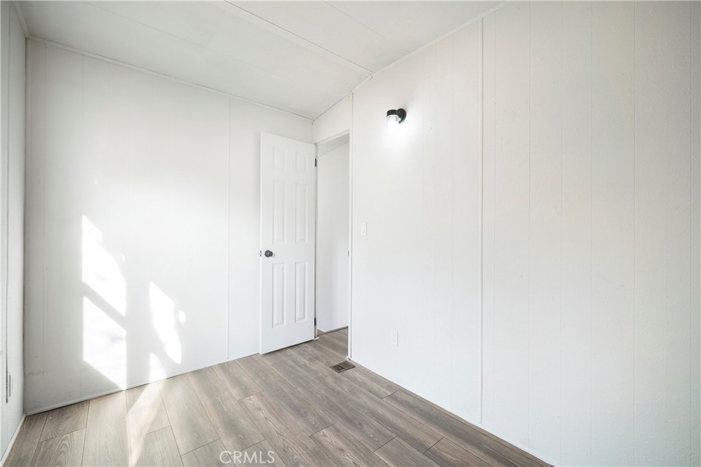 9106 Kennedy Street Riverside, CA 92509 - Photo 9 of 24 a view of an empty room and wooden floor