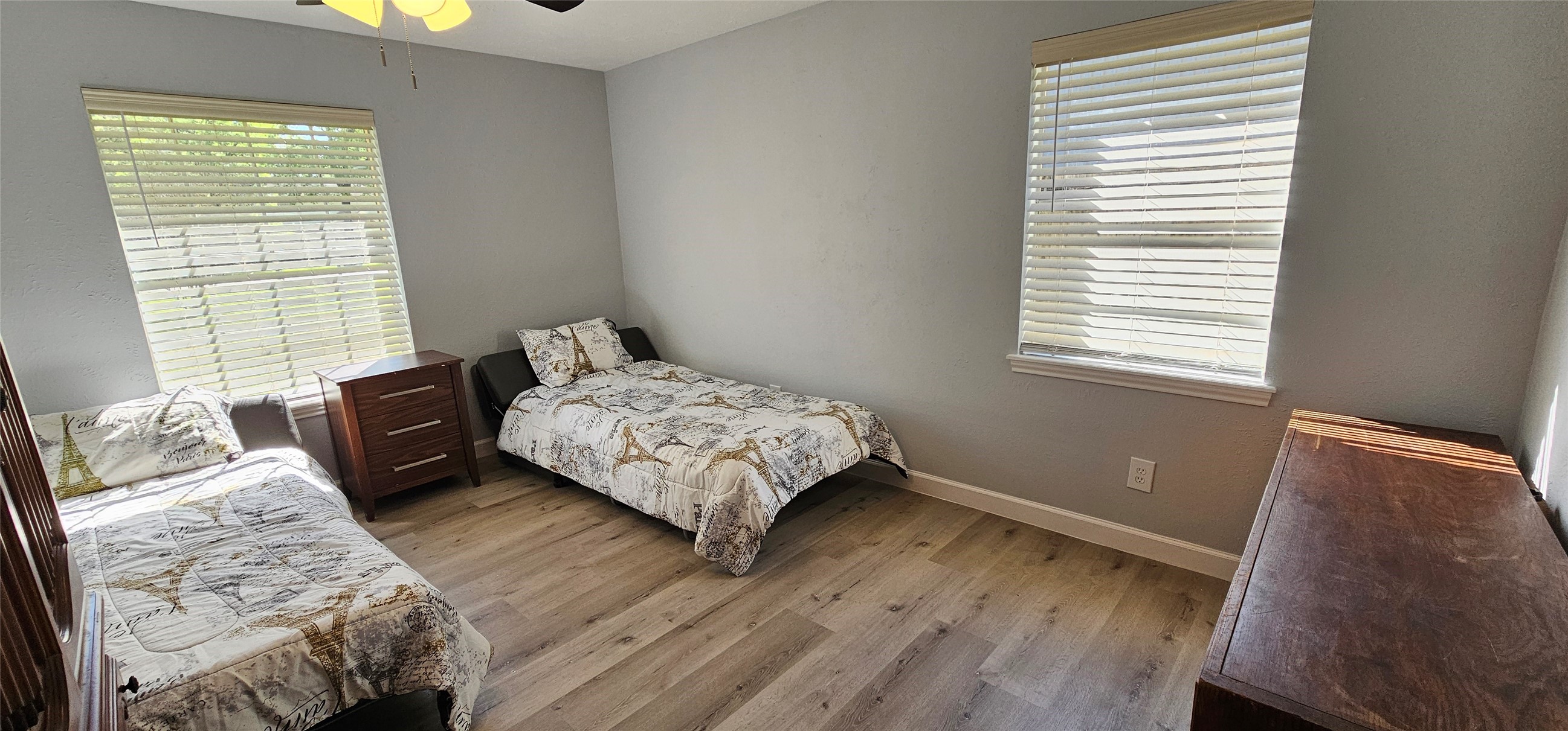 26311 Maplewood Drive Spring, TX 77386 - Photo 11 of 23 a bedroom with a bed and wooden floor