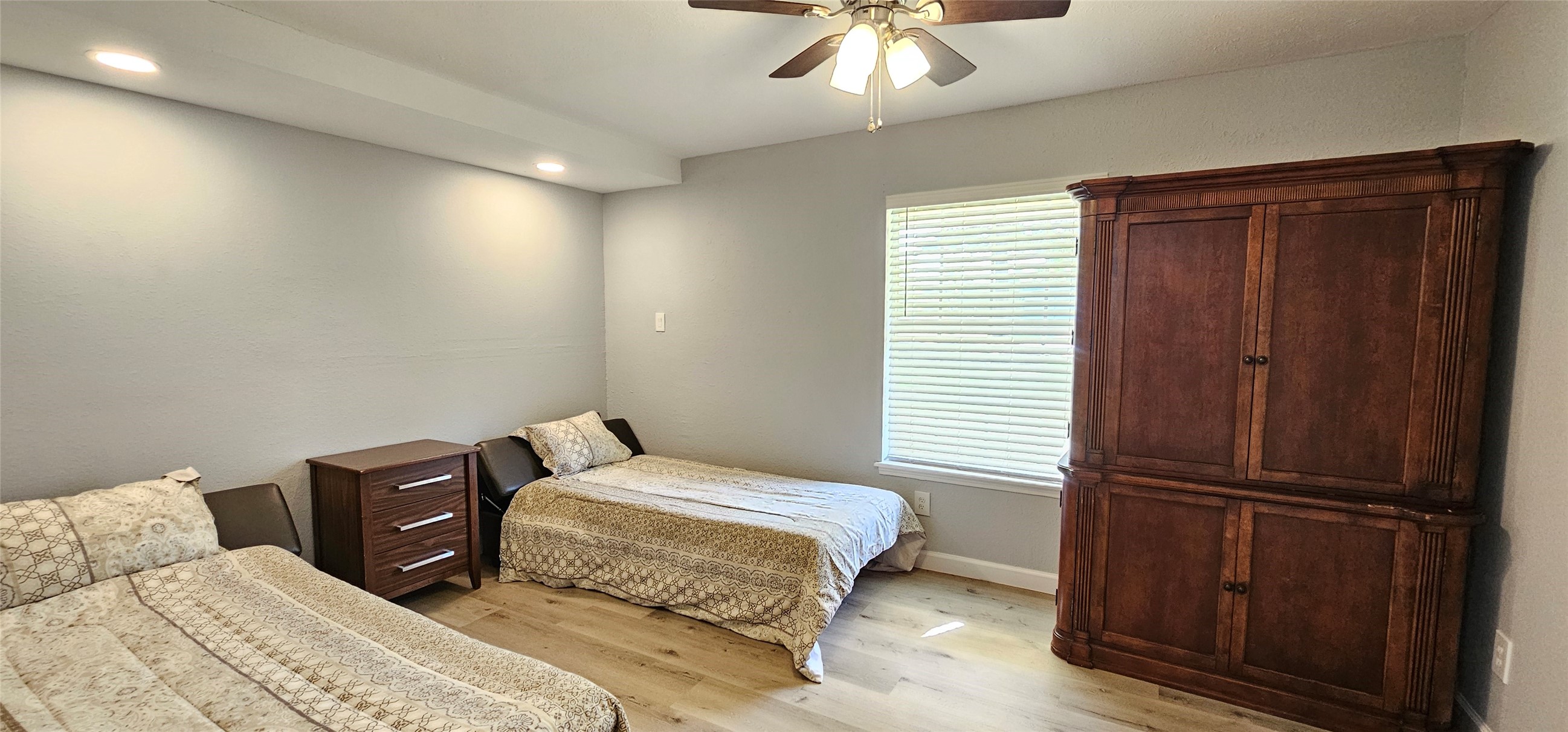 26311 Maplewood Drive Spring, TX 77386 - Photo 14 of 23 a bedroom with a bed and wooden floor