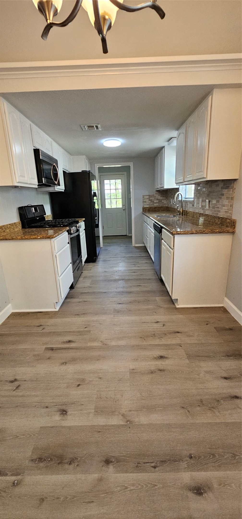 26311 Maplewood Drive Spring, TX 77386 - Photo 5 of 23 a view of kitchen with cabinets and wooden floor
