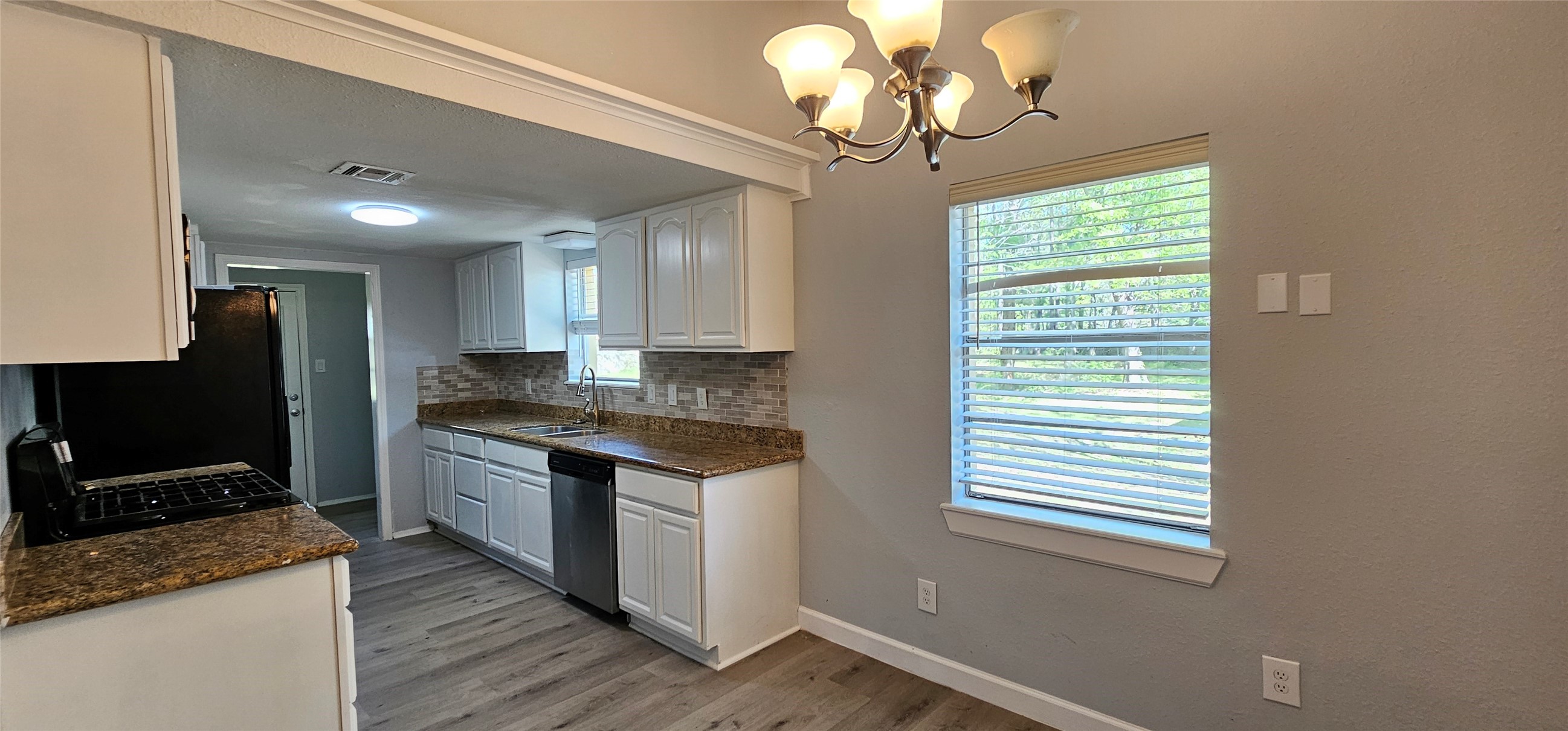 26311 Maplewood Drive Spring, TX 77386 - Photo 6 of 23 a kitchen with stainless steel appliances granite countertop a stove a sink and a microwave
