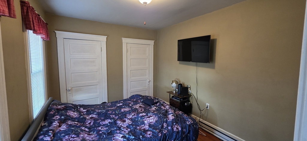 72 Seymour Street, Unit 2 Worcester, MA 01610 - Photo 12 of 18 a bedroom with a bed and a flat screen tv