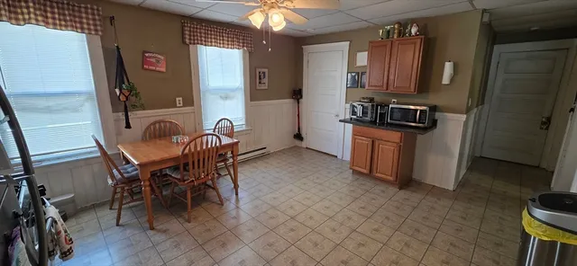 a dining room with furniture and a window