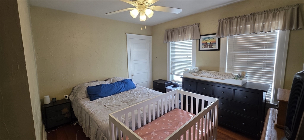 72 Seymour Street, Unit 2 Worcester, MA 01610 - Photo 8 of 18 a bedroom with a bed and a chandelier