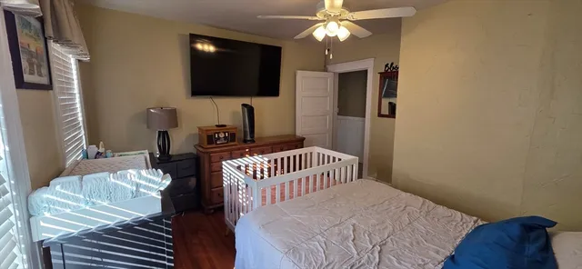 a bedroom with a bed and a flat screen tv