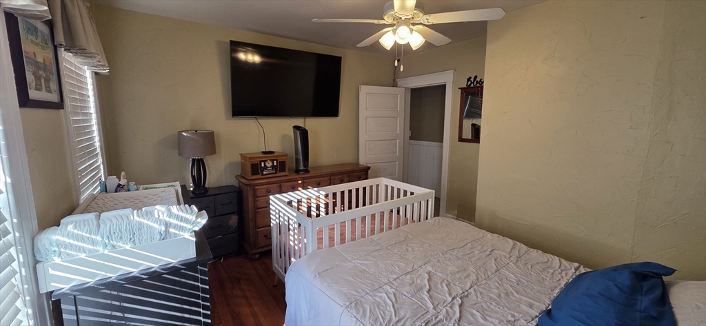 72 Seymour Street, Unit 2 Worcester, MA 01610 - Photo 9 of 18 a bedroom with a bed and a flat screen tv