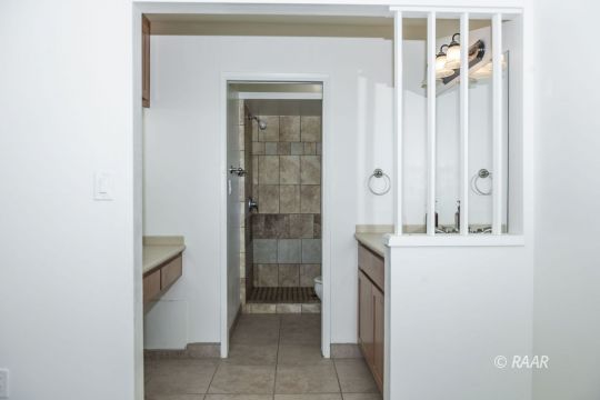 437 Peg Street Ridgecrest, CA 93555 - Photo 26 of 35 a bathroom with a granite countertop sink a mirror and a shower