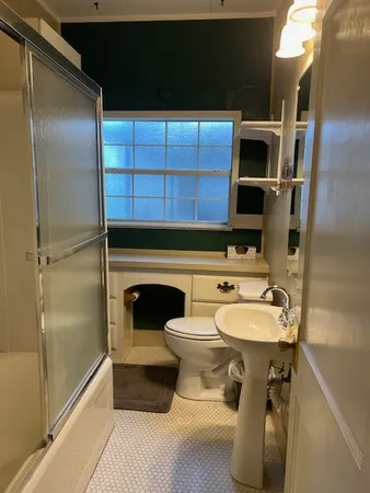 an empty room with wooden floor and closet