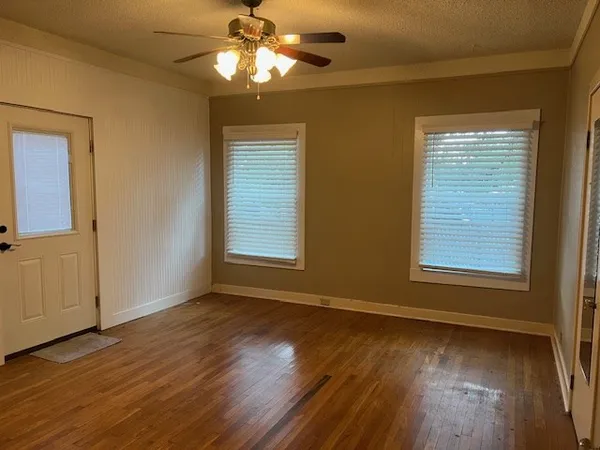 a view of a patio with table and chairs potted plants