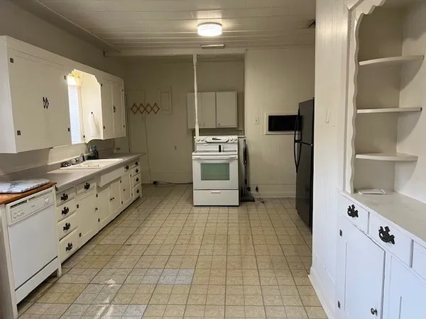 a kitchen with stainless steel appliances a sink a stove and a refrigerator