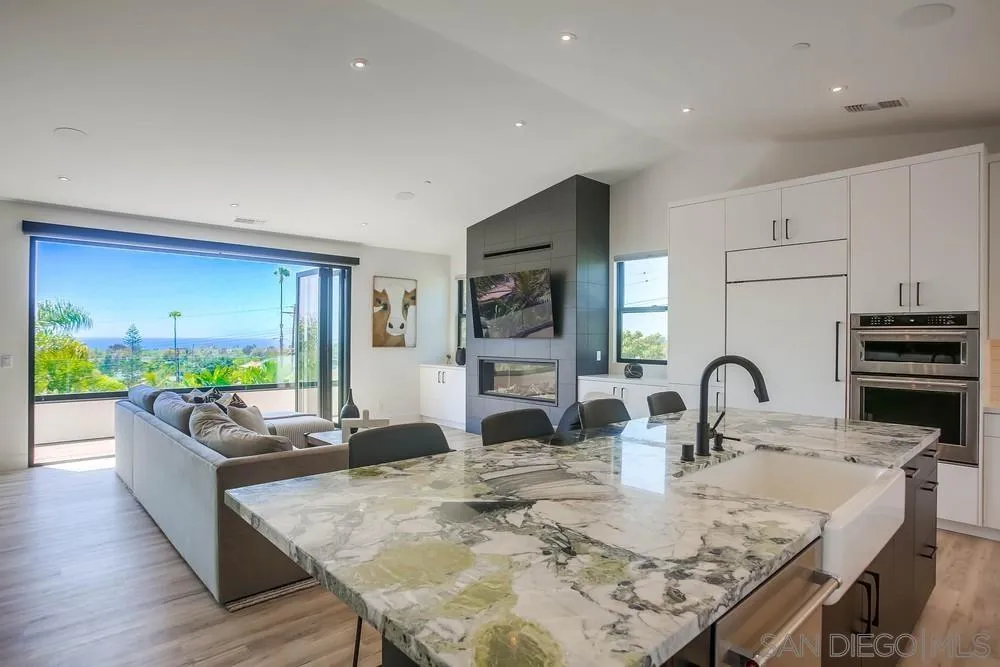 a kitchen with sink a stove and cabinets