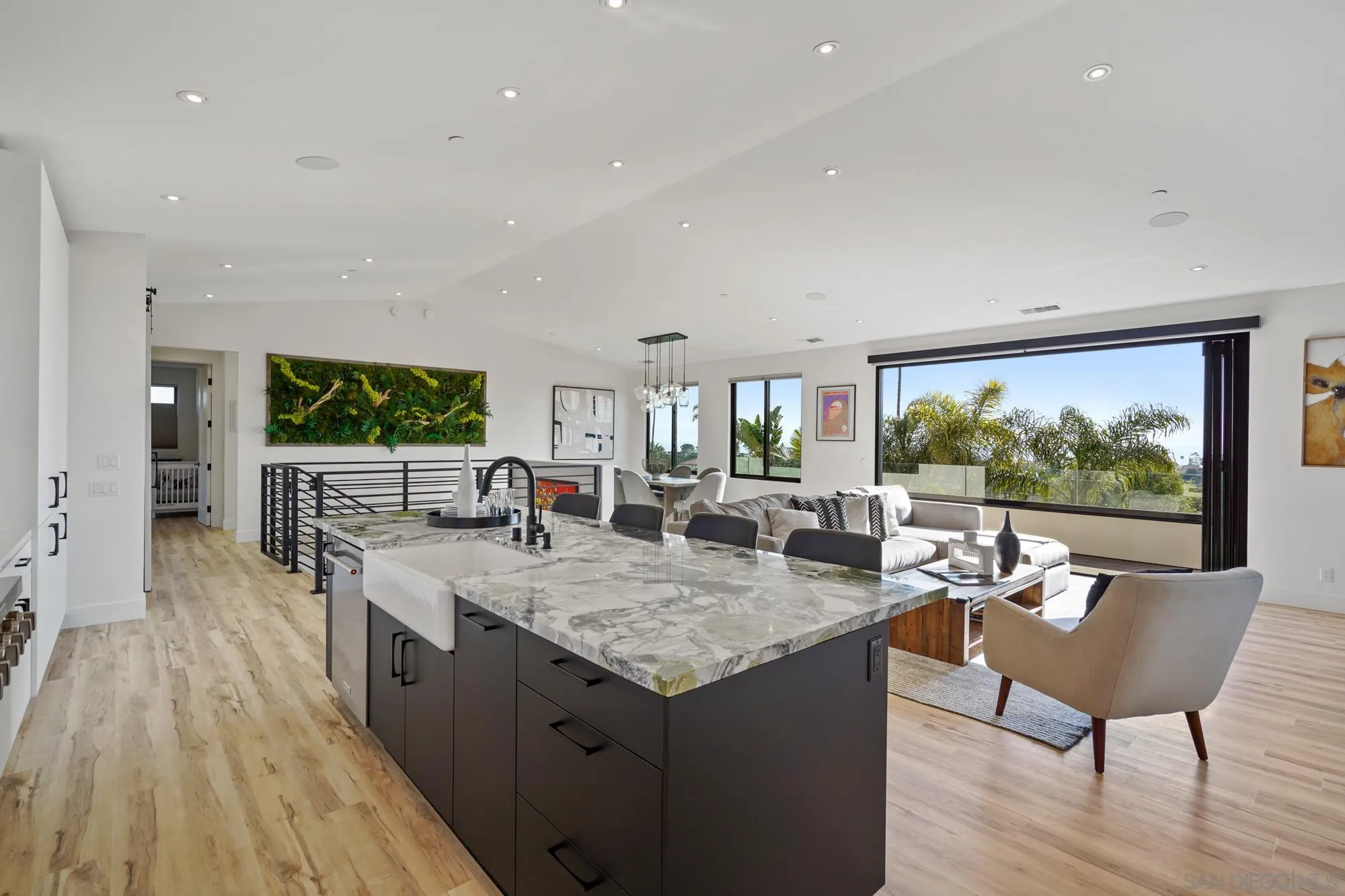 1604 Legaye Drive Cardiff, CA 92007 - Photo 15 of 42 a dining hall with stainless steel appliances granite countertop a stove and a wooden floors