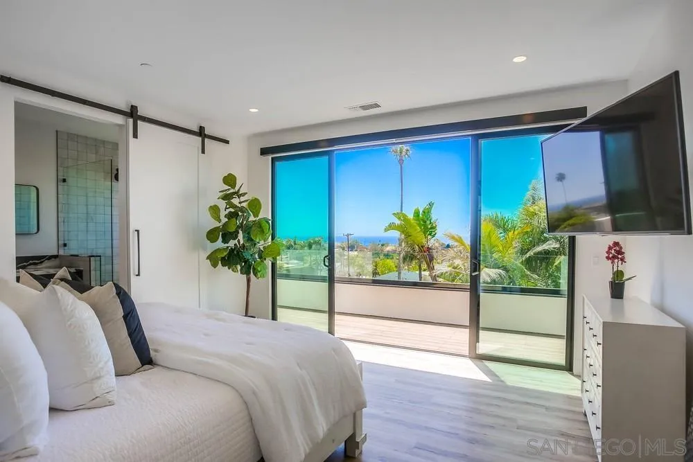 1604 Legaye Drive Cardiff, CA 92007 - Photo 22 of 42 a bedroom with a bed and a potted plant